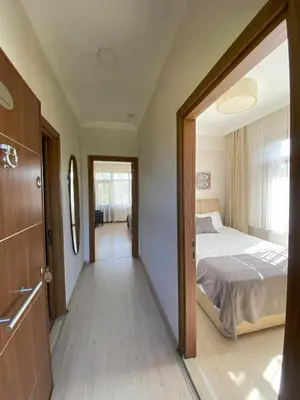 a bedroom with a large bed and a hallway at Kerpe Diem Otel in Kerpe