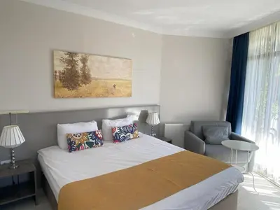 a bedroom with a large bed and a chair at Kerpe Diem Otel in Kerpe
