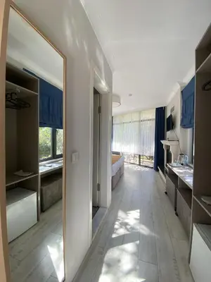 a bathroom with a large mirror in a room at Kerpe Diem Otel in Kerpe