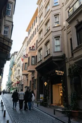 a group of people walking down a street with buildings at Galata Maison by Guest Teori in Istanbul