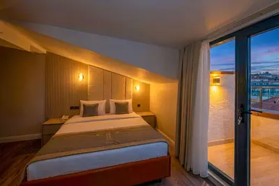 a bedroom with a large bed and a large window at Tumar Istanbul Hotel in Istanbul