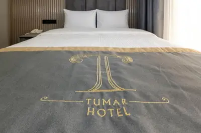 a hotel sign on a bed with a trump hotel at Tumar Istanbul Hotel in Istanbul
