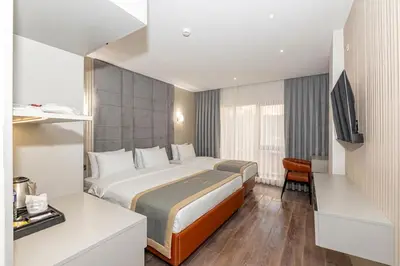 a hotel room with a bed and a television at Tumar Istanbul Hotel in Istanbul