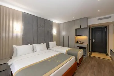 a hotel room with two beds and a bathroom at Tumar Istanbul Hotel in Istanbul