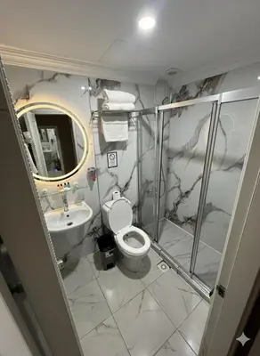 a bathroom with a shower and a toilet and a sink at B Corner Hotel Bistro in Istanbul