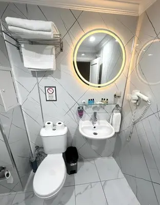 a bathroom with a toilet and a sink and a mirror at B Corner Hotel Bistro in Istanbul