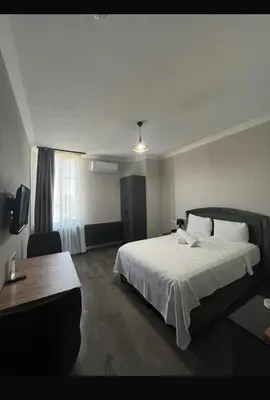 a hotel room with a large bed and a desk at ergene park hotel