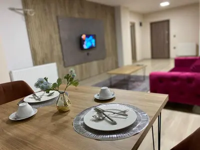 a dining room table with plates and silverware on it at Luxury Suit