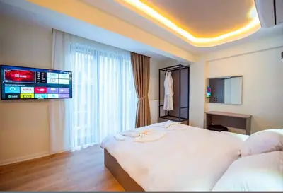 a hotel room with a bed and a flat screen tv at Mar Boutique Hotel in Istanbul