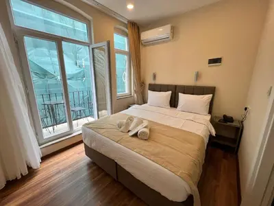 a bedroom with a large bed with two shoes on it at 360 NACRE taksim in Istanbul