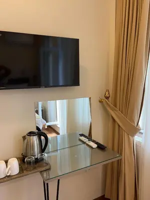 a glass table with a television on a wall at 360 NACRE taksim in Istanbul
