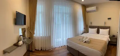 a bedroom with a bed and a large window at 360 NACRE taksim in Istanbul