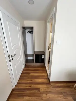 a hallway with a white door and a wooden floor at 360 NACRE taksim in Istanbul