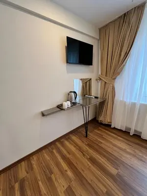 a room with a table and a tv on a wall at 360 NACRE taksim in Istanbul