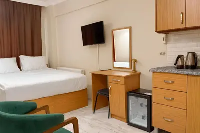 a hotel room with a bed and a mirror at Lion Stone Hotel in Istanbul