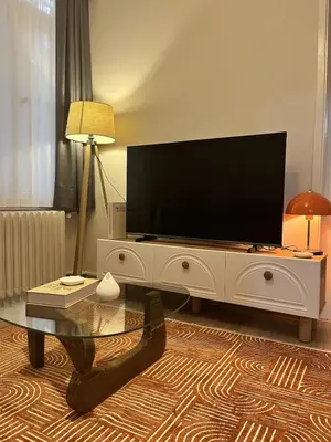 a living room with a flat screen tv on a white entertainment center at Modern Apartment in the Heart of Kadıköy in Istanbul