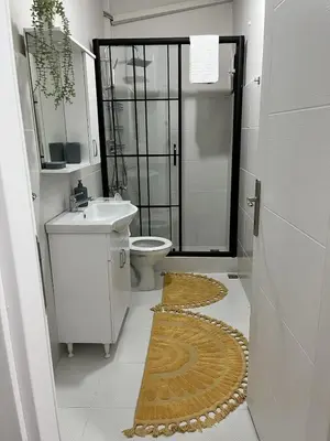 a bathroom with a toilet and a sink and a shower at Modern Apartment in the Heart of Kadıköy in Istanbul