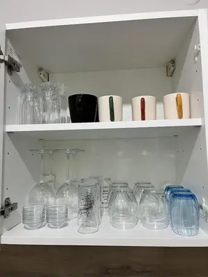 a shelf with glass jars and other items on it at Modern Apartment in the Heart of Kadıköy in Istanbul