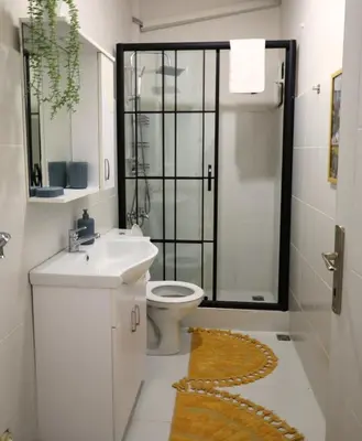 a bathroom with a toilet and a sink and a shower at Modern Apartment in the Heart of Kadıköy in Istanbul