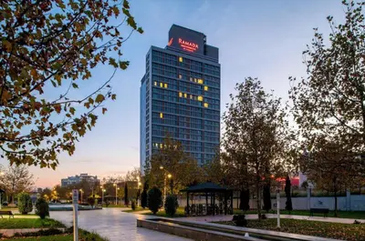 a tall building with a krispy kreme sign on it at Ramada Residences by Wyndham Istanbul Haramidere in Istanbul