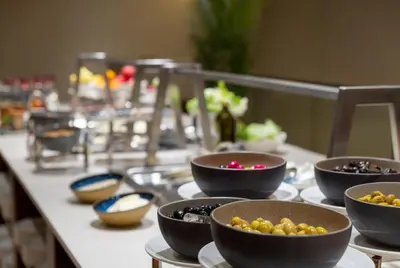 a buffet with bowls of food on a table at Ramada Residences by Wyndham Istanbul Haramidere in Istanbul