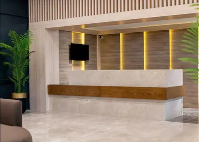 a lobby with a reception desk with a television on it at Ramada Residences by Wyndham Istanbul Haramidere in Istanbul