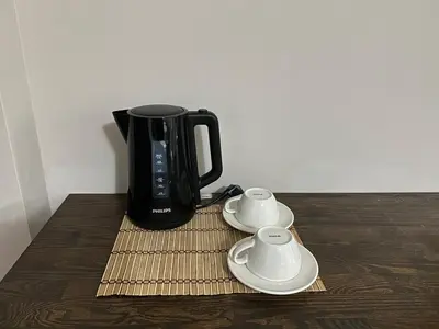 a black coffee pot sitting on top of a wooden table at Pera Line Yalova in Yalova