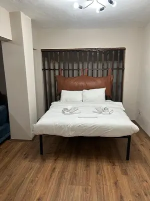 a bedroom with a large bed with a wooden floor at Pera Line Yalova in Yalova