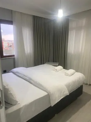 a bedroom with a bed with white sheets and a window at historic stay istanbul in Istanbul