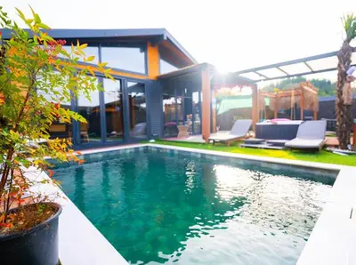 a swimming pool in front of a house at Palmera suit in Sapanca
