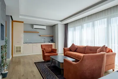 a living room with a couch and two chairs at My SUİTES in Istanbul
