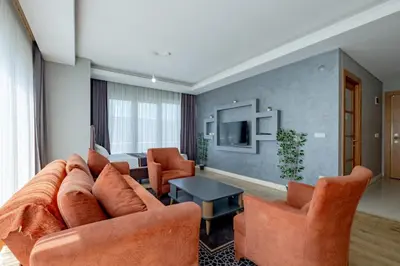 a living room with a couch and chairs and a television at My SUİTES in Istanbul