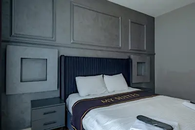 a bedroom with a bed with a remote control on it at My SUİTES in Istanbul