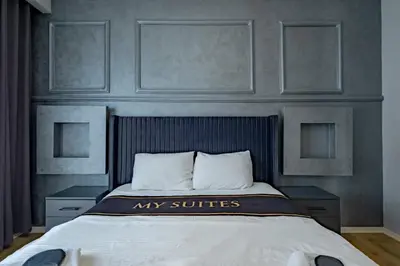 a bedroom with a bed with my suites sign on it at My SUİTES in Istanbul
