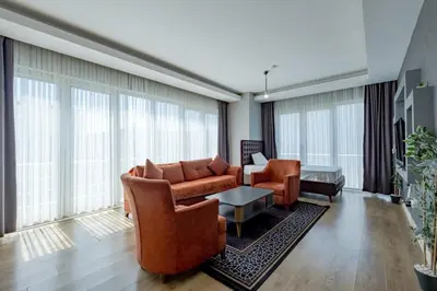 a living room with leather furniture and large windows at My SUİTES in Istanbul