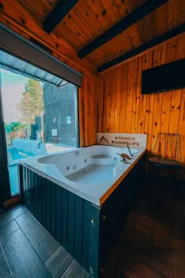 a bath tub in a room with a large window at Sapanca bungalife in Sapanca