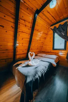a bedroom with a bed in a wooden cabin at Sapanca bungalife in Sapanca