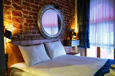 a bedroom with a bed with a mirror on the wall at İstanbul Galata Squit Apartments in Istanbul