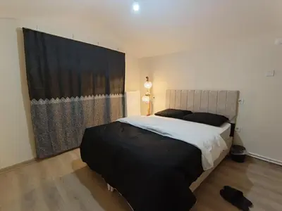 a bedroom with a bed with a black and white comforter at Do Not Disturb Suites in Istanbul