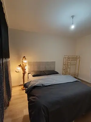 a bedroom with a bed and a lamp on the floor at Do Not Disturb Suites in Istanbul
