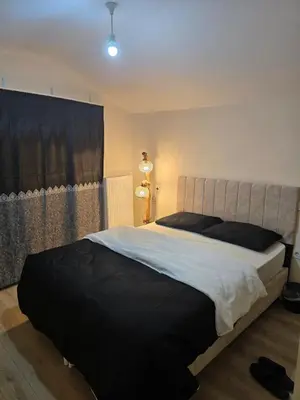 a bedroom with a large bed with black pillows at Do Not Disturb Suites in Istanbul