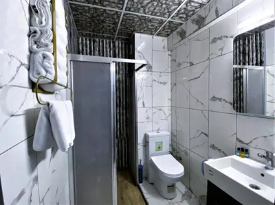 a bathroom with a toilet and a sink at Orange Airport Hotel in Istanbul