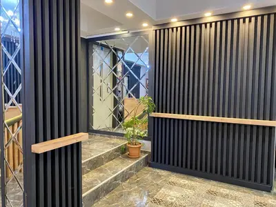 a room with black wood partitioning with a plant at Orange Airport Hotel in Istanbul