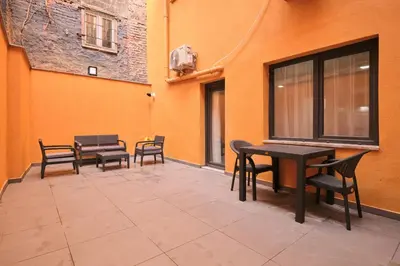 a patio with tables and chairs on a building at Ulker Apartments in Istanbul