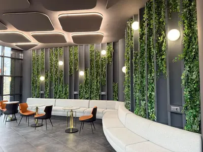 a lobby with a white couch and chairs and plants at H-mak AIRPORT OTEL in Arnavutköy
