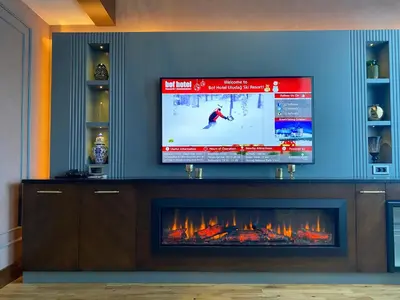 a living room with a tv and a fireplace at Bof Hotels Uludağ Ski&Luxury Resort All Inclusive in Uludag