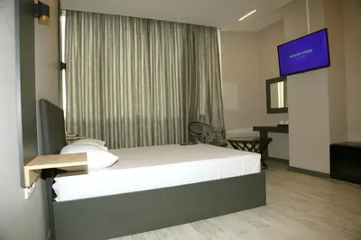 a hotel room with a bed and a flat screen tv at Zoom Airport Hotels in Istanbul