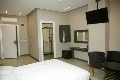 a bedroom with a bed and a table and a mirror at Zoom Airport Hotels in Istanbul