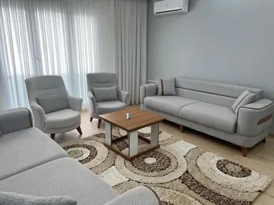 a living room with couches and chairs and a coffee table at Bediroğlu Airport Apart in Arnavutköy