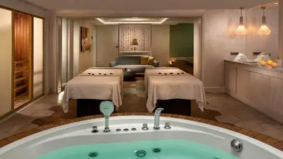 a hotel room with a bath tub and a living room at Crowne Plaza Florya Istanbul by IHG in Istanbul
